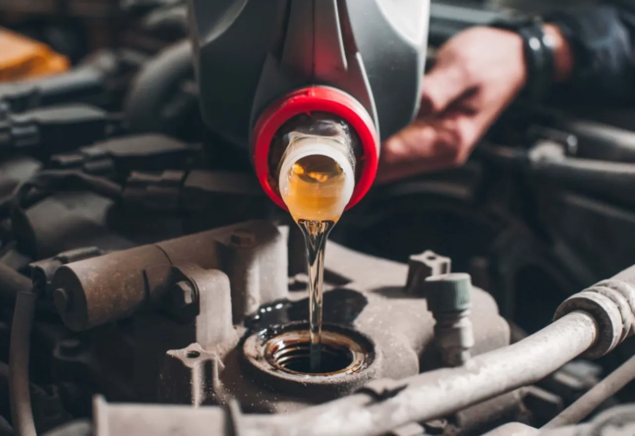 Oil change in South Florida with fresh motor oil poured into a heavy-duty engine bay.
